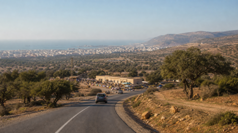 Road through argan country in the Souss with Agadir and the Atlantic behind