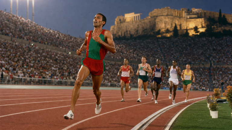 Editorial reconstruction of a Moroccan distance runner leading in an Athens stadium
